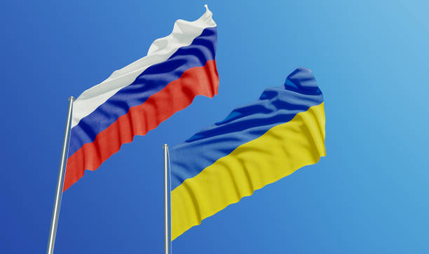 image of ukrainian and russian flags flying side by side