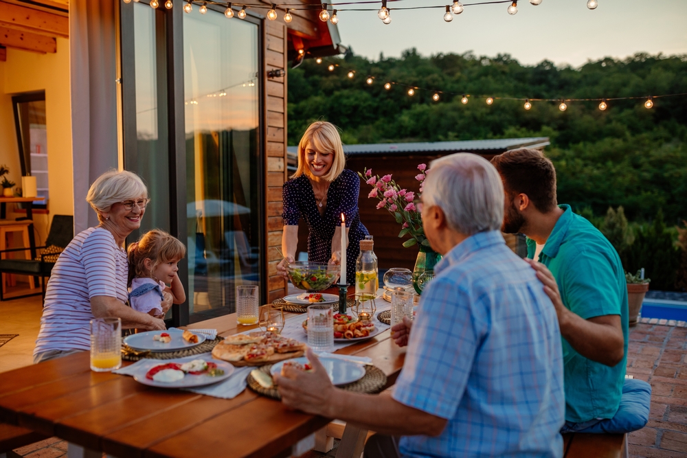 Cheerful,Three,Generations,Family,Having,Dinner,Together,Around,A,Table